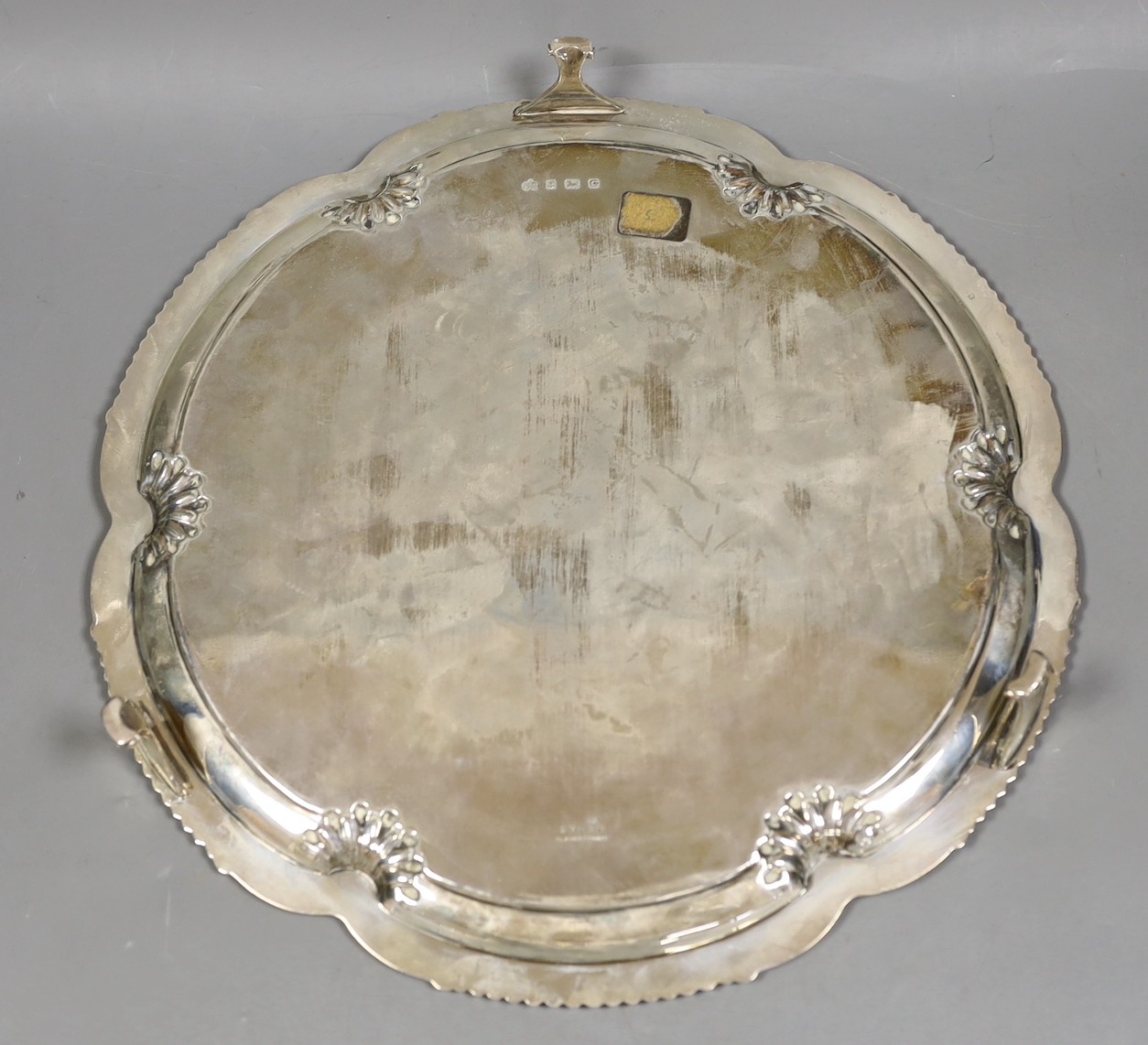 A George V shaped circular silver salver by Elkington & Co, Birmingham, 1931, with engraved initials, 30cm, 27.1oz.